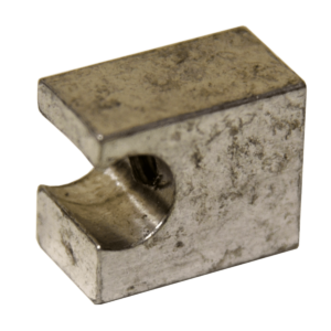 Weathered metal bracket with a circular hole, likely a mounting clamp piece used to secure a rod or bolt.