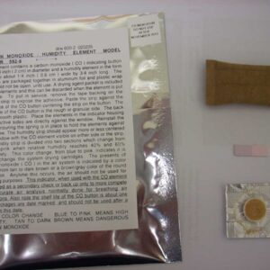 CO detector test packet with instruction sheet and a small brown desiccant strip on a white surface