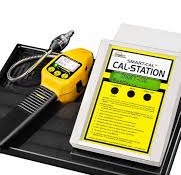 Emergency call station with a yellow control unit and handset on a black base.