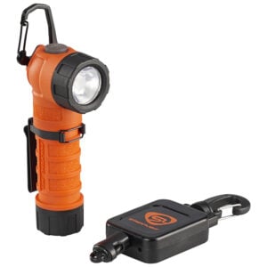 Orange rugged flashlight with a large front lens and textured grip, shown with a black magnetic charging block with a carabiner clip
