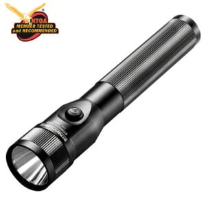 Black tactical flashlight with ribbed grip and side switch; NTOA 'Member Tested and Recommended' badge in the top-left corner.