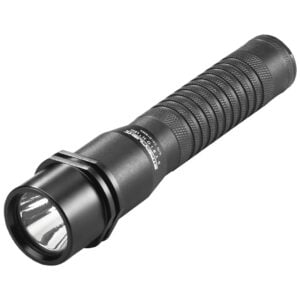 Black tactical flashlight with a knurled grip and prominent front lens facing the viewer, close-up.