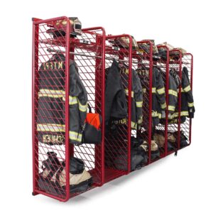 Row of red metal lockers with firefighter turnout gear hanging inside, including jackets, pants, helmets, and boots.