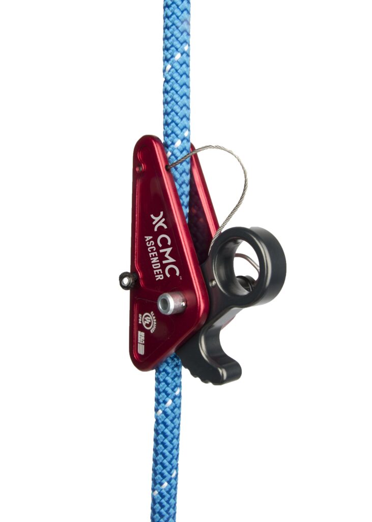 Red CMC Ascender attached to a bright blue climbing rope, used for rope ascent and belaying, shown from the side with a pulley and strap loop visible.
