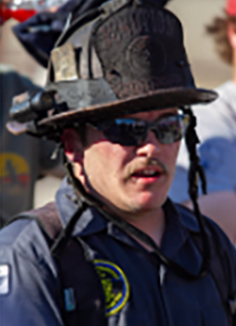 Erik Johnson in fire fighter helmet and sunglasses looking pretty cool