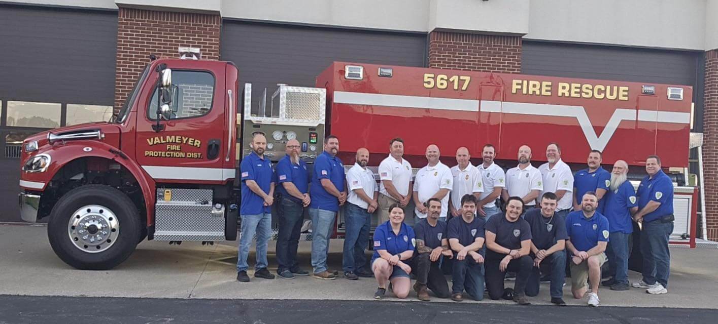 Group photo of fire department crew in front of new Firemaster Tanker