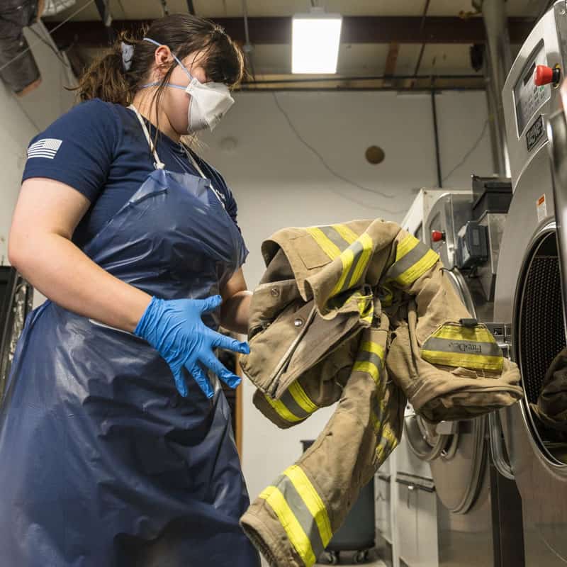Gear wash working to get turnout gear in to the wash machine