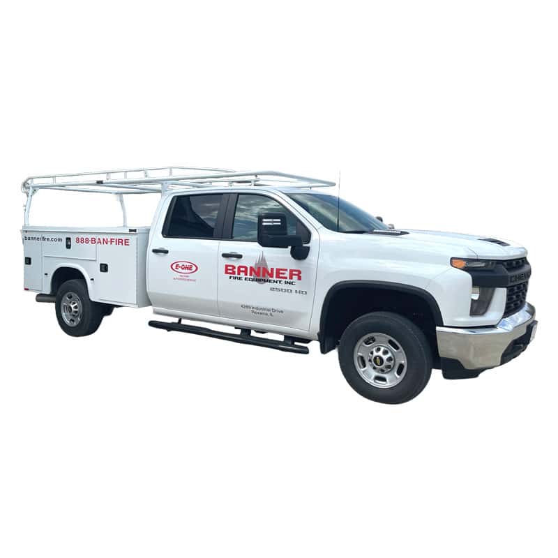 White service pickup truck for Banner Fire Equipment, with a rung ladder rack and company logos on the door and side panels