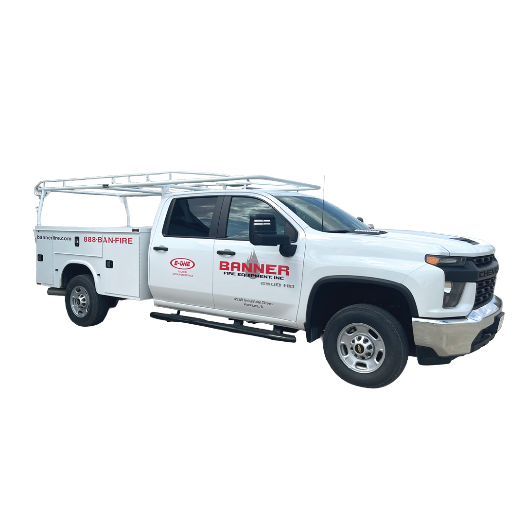 White utility truck with a tall ladder rack, Banner Fire Equipment branding, and '888-BAN-FIRE' on the side; company contact and address shown on door.