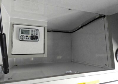 Built-in security safe with a keypad lock mounted inside a gray metal cabinet.
