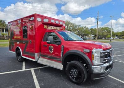Red Blackwell Fire Department ambulance parked in an empty lot, front-right view