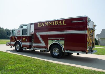 Red fire engine parked on a driveway with Hannibal branding along the side