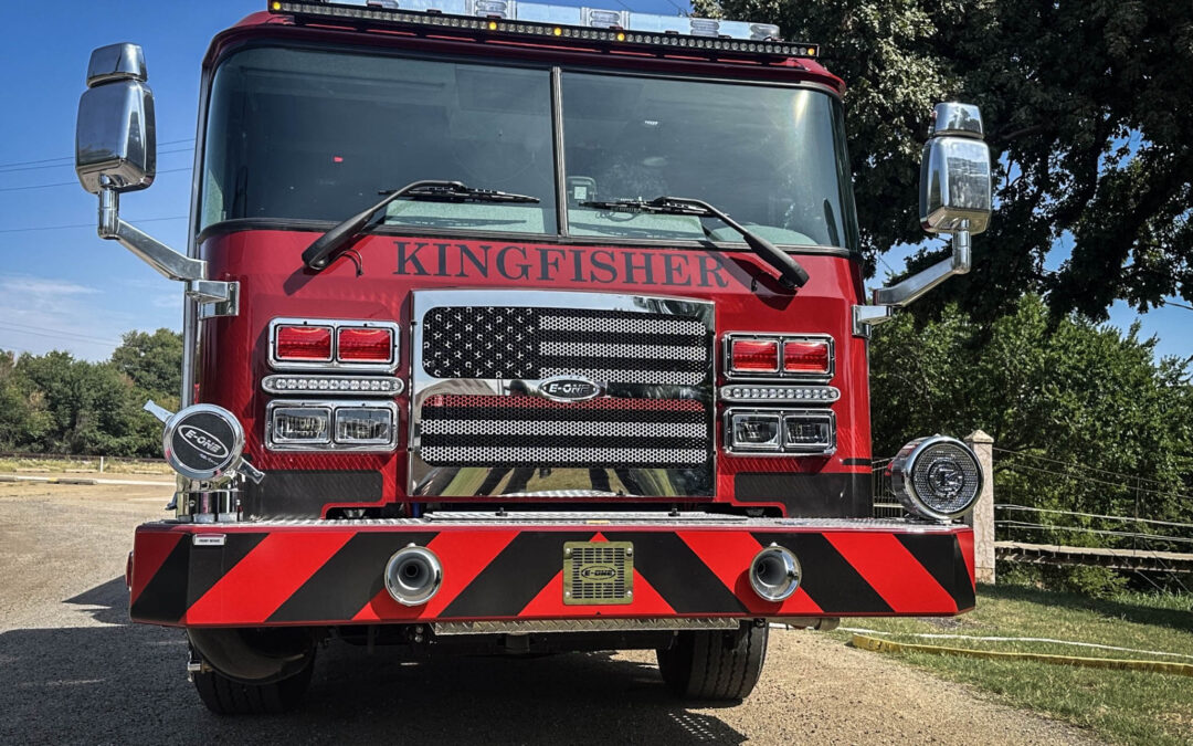 Front view of a red fire truck with KINGFISHER lettering and chrome grille, mirrors, and lights.