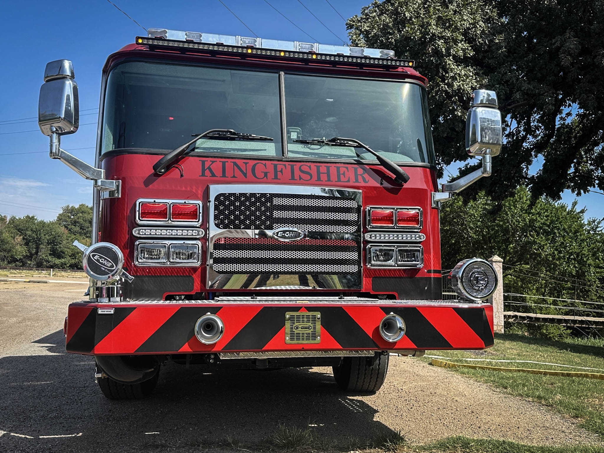 Front view of a red fire truck with KINGFISHER lettering and chrome grille, mirrors, and lights.